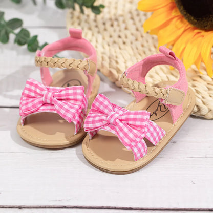 Adorable pink princess bow sandals for toddlers, perfect anti-slip baby girl shoes.