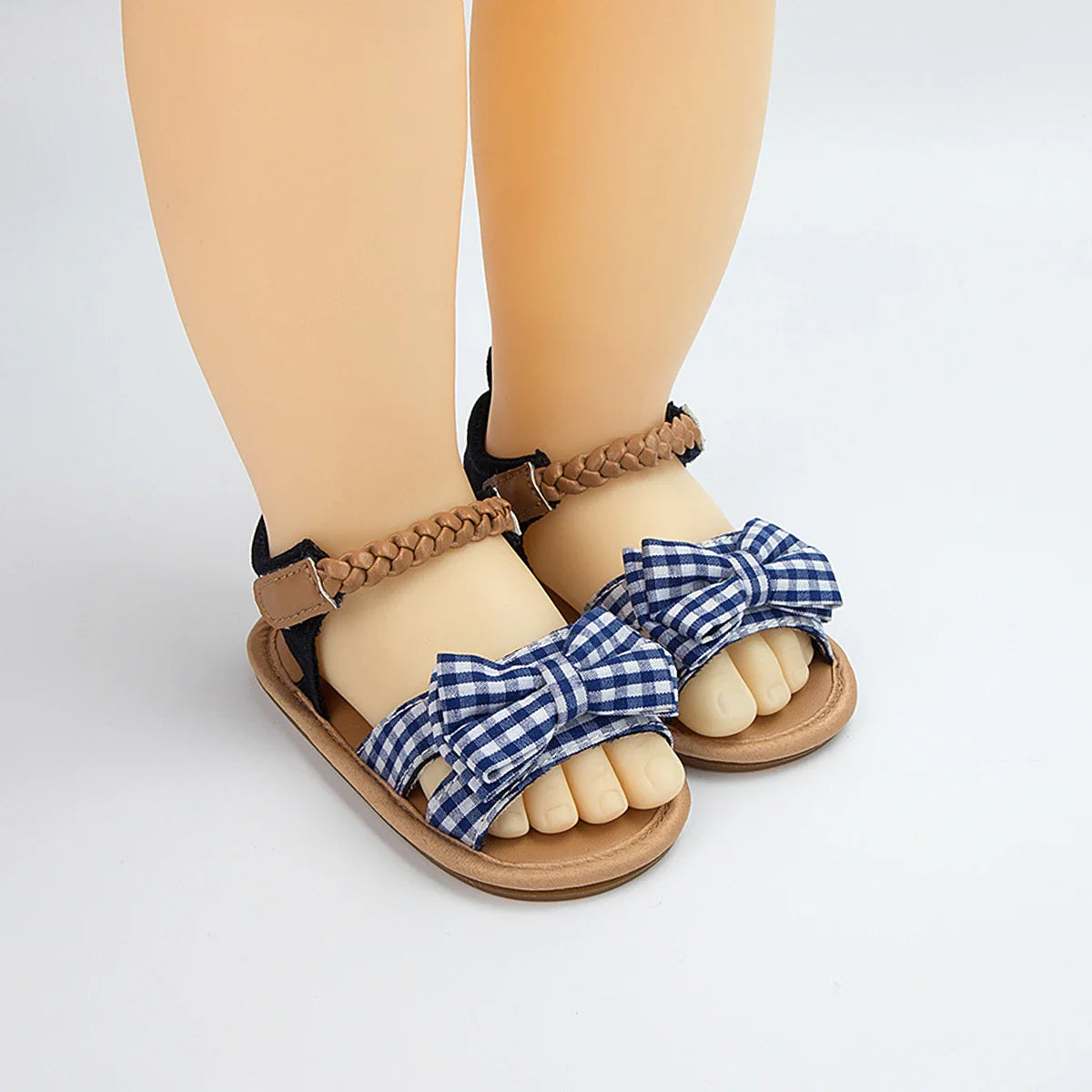 Baby girl's pink sandals with a prominent princess bow, ideal for summer outfits.