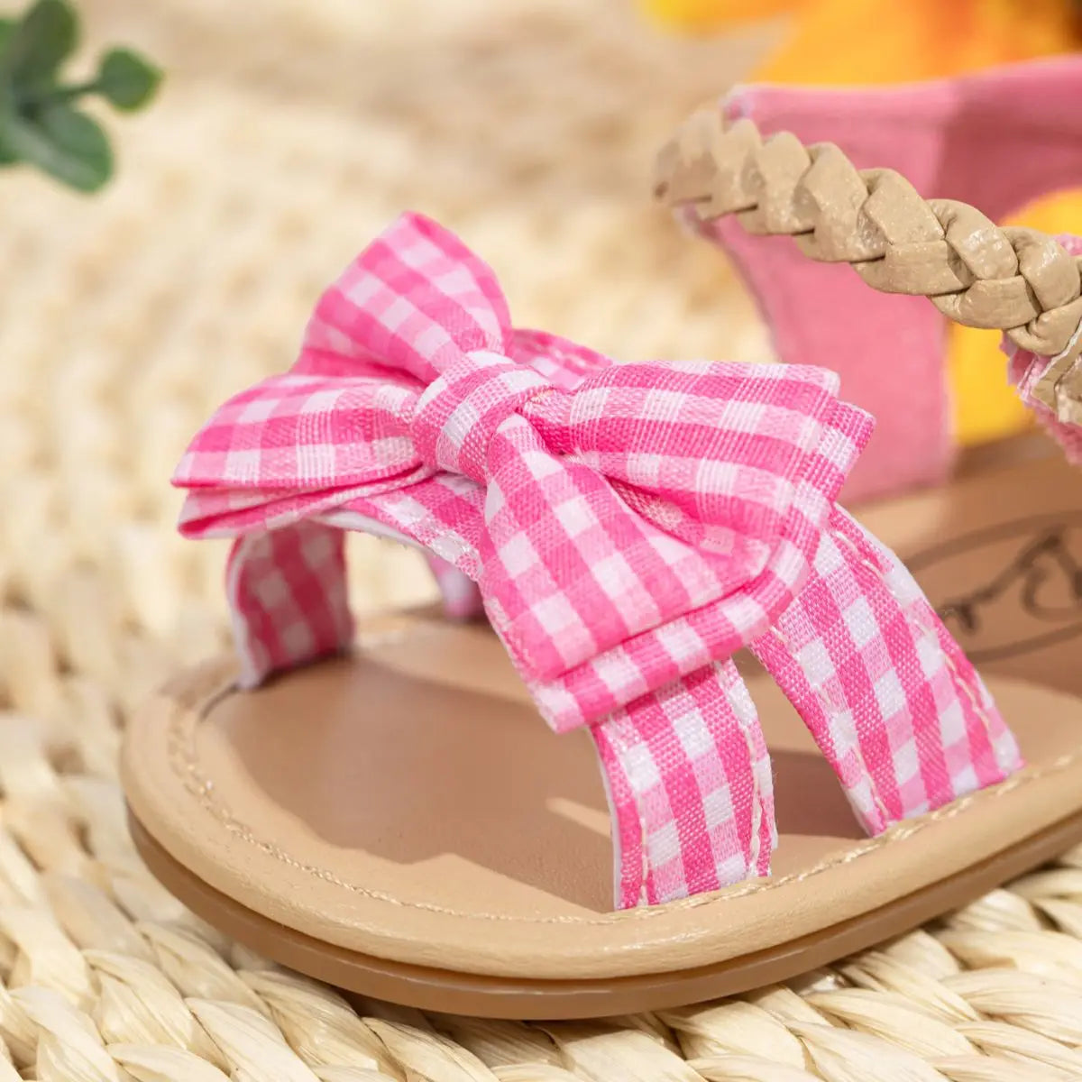 Close-up of pink baby girl sandals featuring a charming princess bow and anti-slip sole.