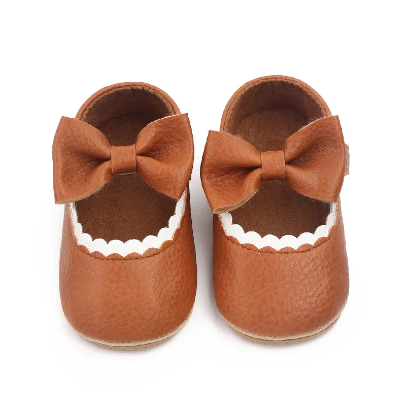 Newborn prewalker shoes with an elegant bowknot and reliable anti-slip sole.