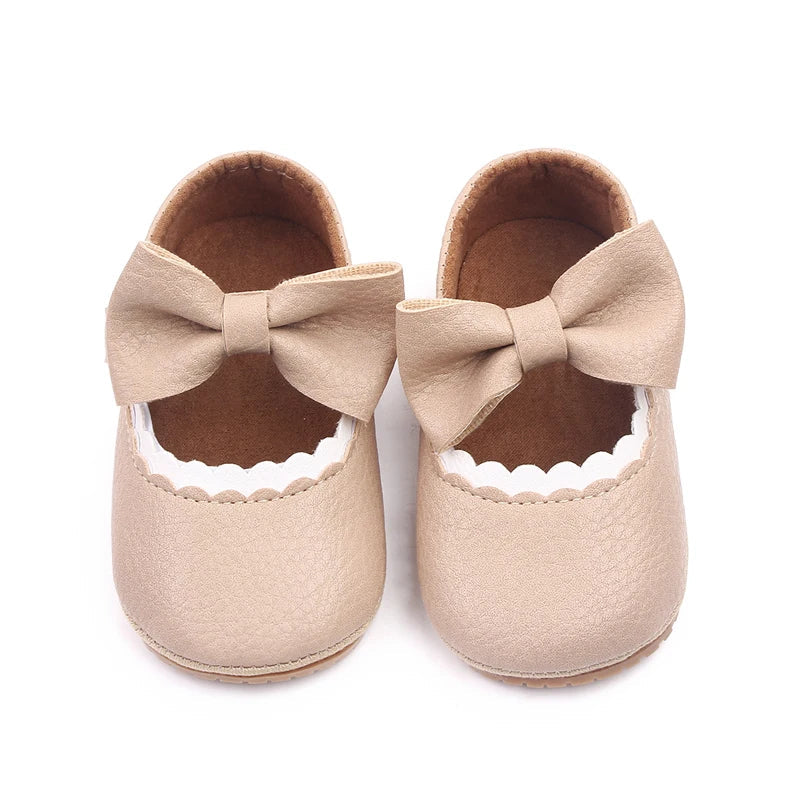 Newborn baby prewalker shoes with a charming bowknot design, anti-slip sole.