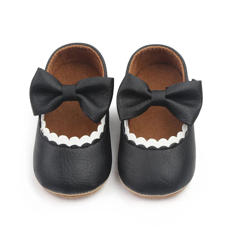 Baby girl's prewalker shoes with a stylish bowknot, ensuring safe steps.