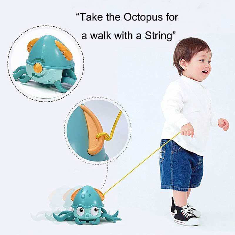 Toddler holding a cute wind-up octopus bath toy