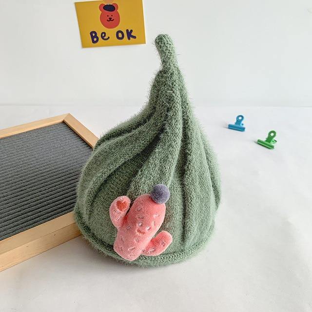 Infant wearing a cozy knit gnome beanie, perfect for keeping warm during winter activities.