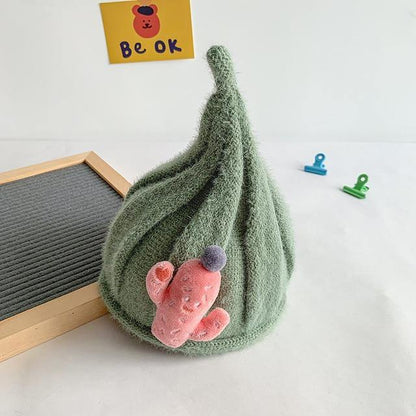 Infant wearing a cozy knit gnome beanie, perfect for keeping warm during winter activities.