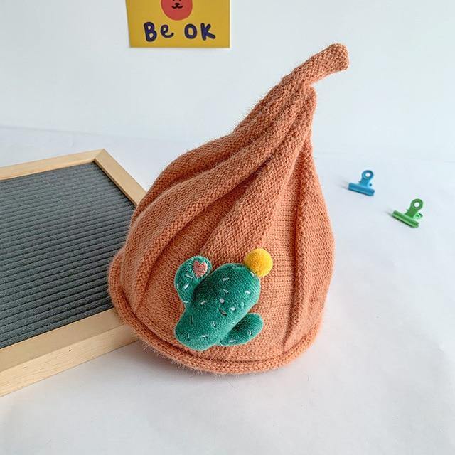 Display of various colored knit gnome hats for baby & toddler, perfect winter accessories.