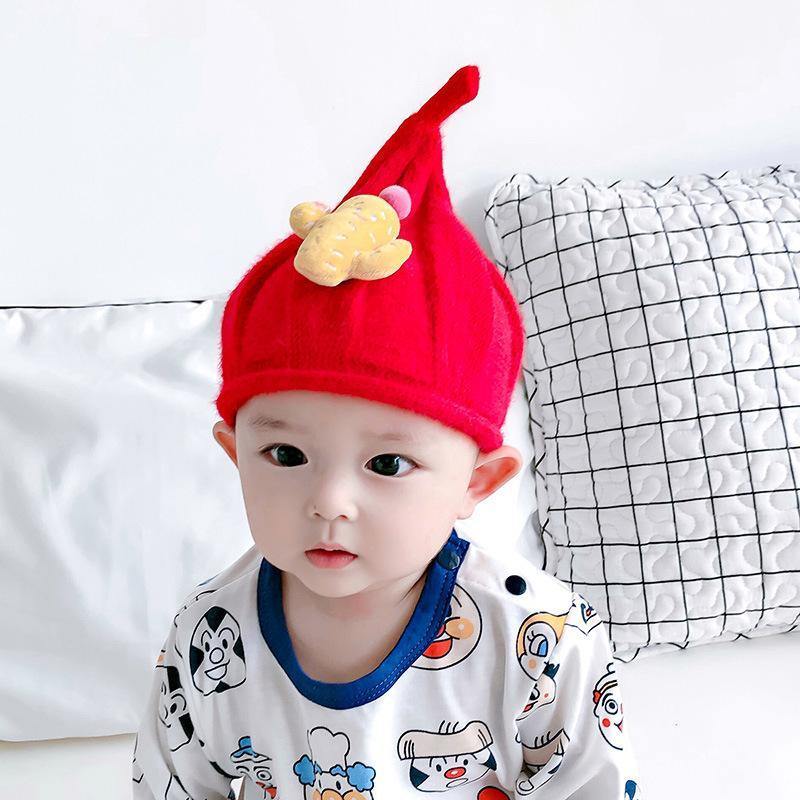 Close-up of the fuzzy cotton wool on a knit gnome hat, soft and gentle for baby's skin.