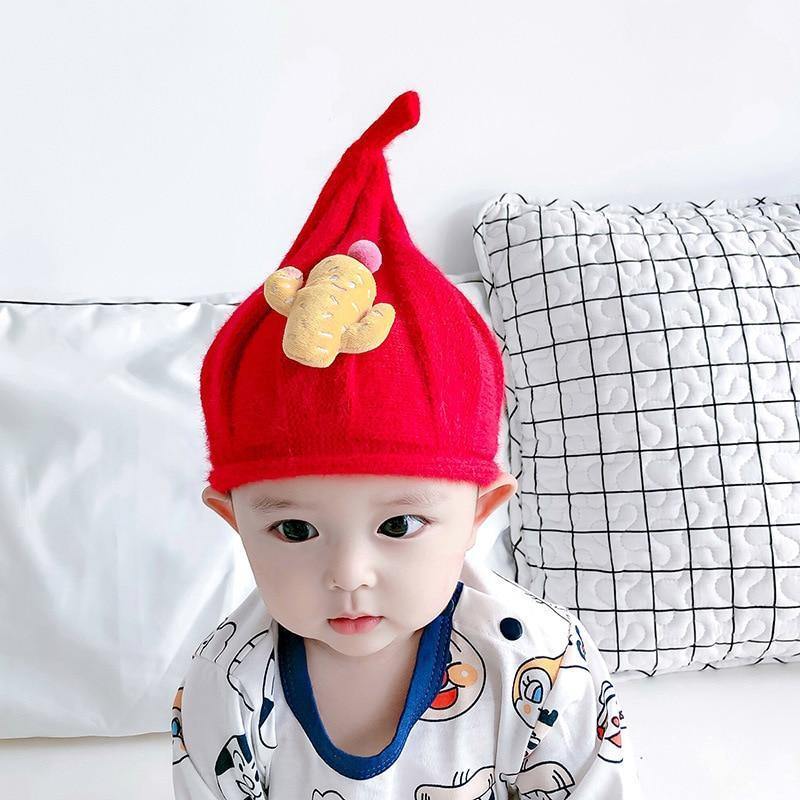Cute toddler gnome hat in knit cotton wool, featuring a tall point, ideal for holiday accessory.