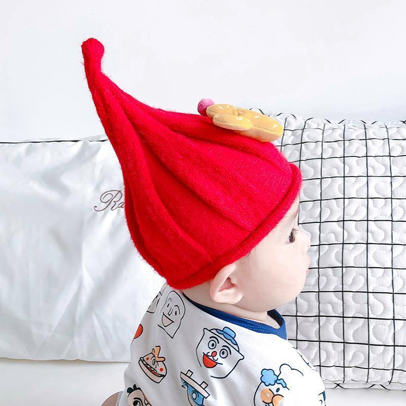 Baby's knit gnome beanie in cream, cozy and warm, a charming accessory for cold weather.