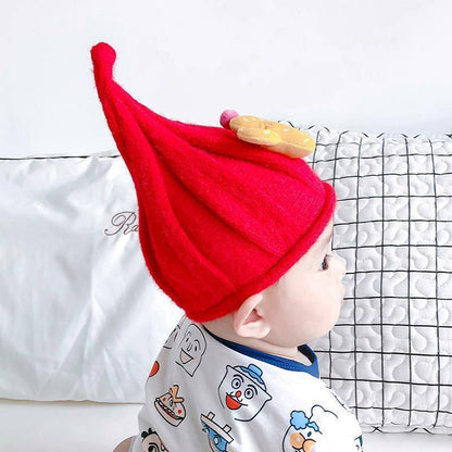 Baby's knit gnome beanie in cream, cozy and warm, a charming accessory for cold weather.