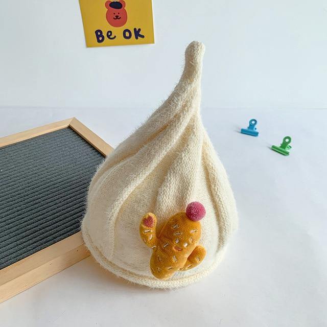 Close-up of a knit gnome beanie in grey, highlighting the cotton wool texture, baby fashion.