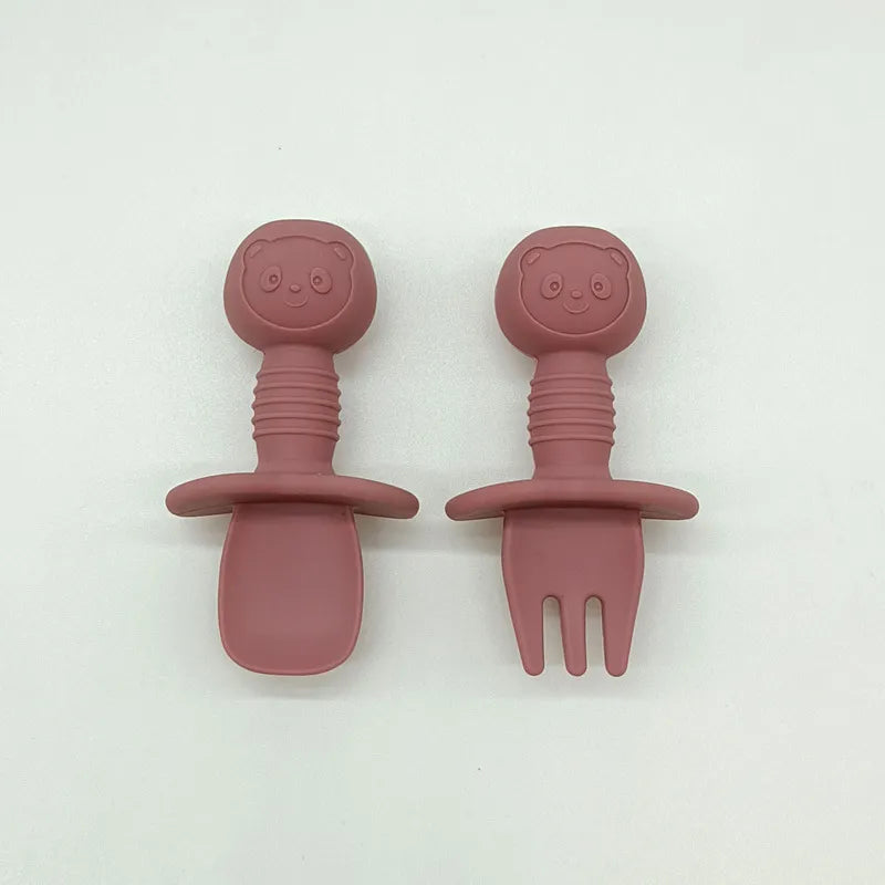 Overhead shot of a complete silicone bear baby feeding set on a highchair tray, BPA free
