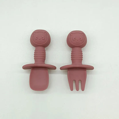 Overhead shot of a complete silicone bear baby feeding set on a highchair tray, BPA free