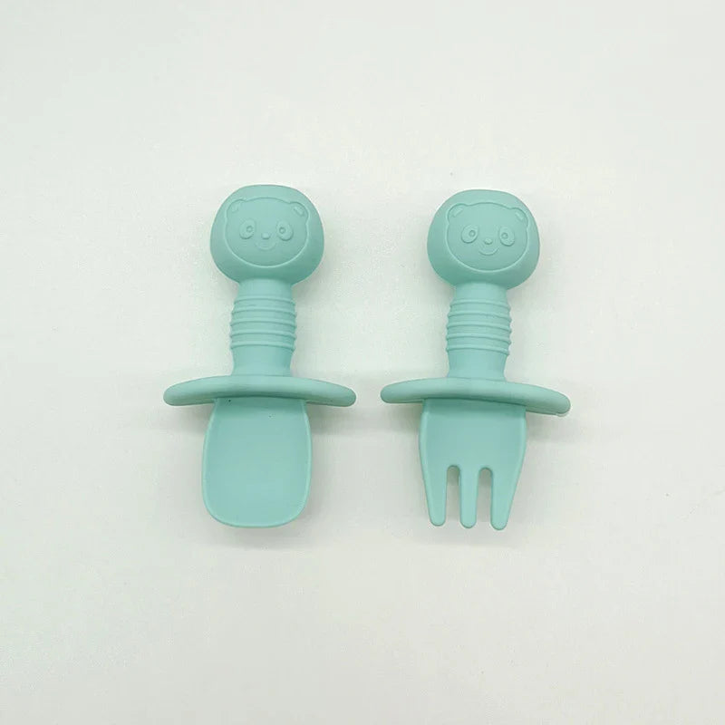 Packaging showing the silicone bear baby fork and spoon set, highlighting its safety features