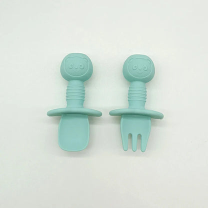 Packaging showing the silicone bear baby fork and spoon set, highlighting its safety features