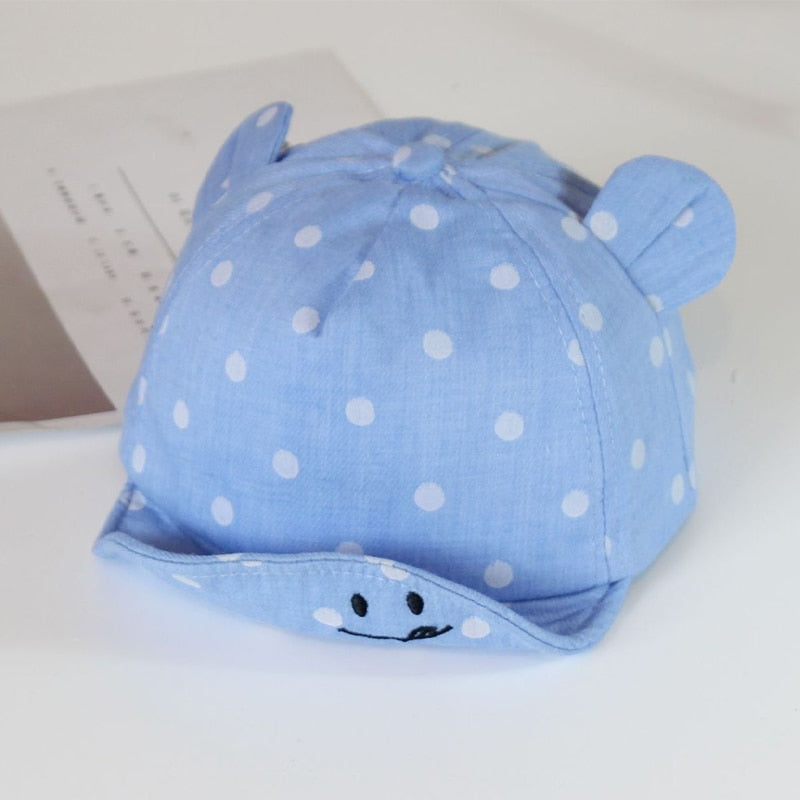 Unisex baby sun hat, 100% cotton with blue polka dots, perfect breathable infant headwear.