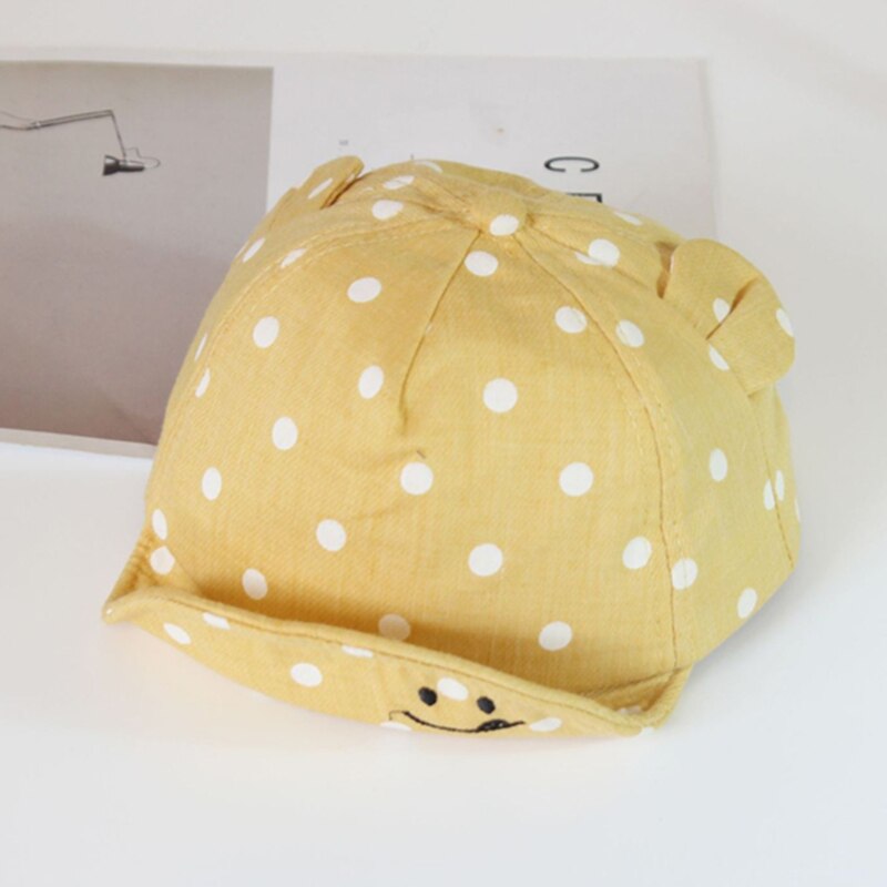 Toddler sun hat with a wide brim, featuring playful polka dots, essential baby accessories for summer.
