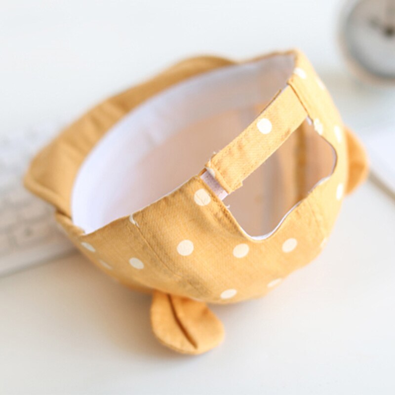 Cute yellow polka dot cotton sun hat for toddlers, a stylish and protective summer hat for infants.