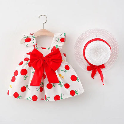Cute girls' fruit print cotton summer dress with round neck and short sleeves, paired with a stylish straw hat