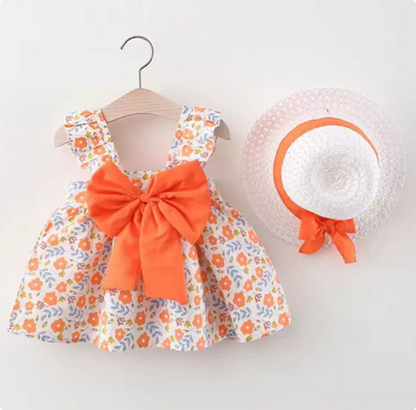 Soft cotton girls' summer dress featuring colorful fruit patterns, accessorized with a natural straw hat