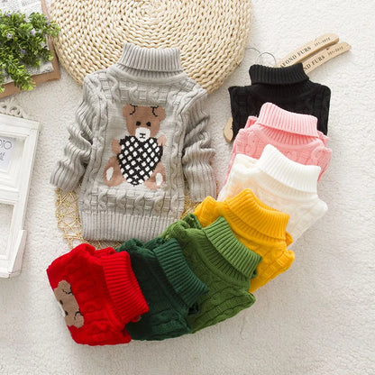 Adorable toddler in a plush teddy bear turtleneck sweater, perfect for winter warm clothes.