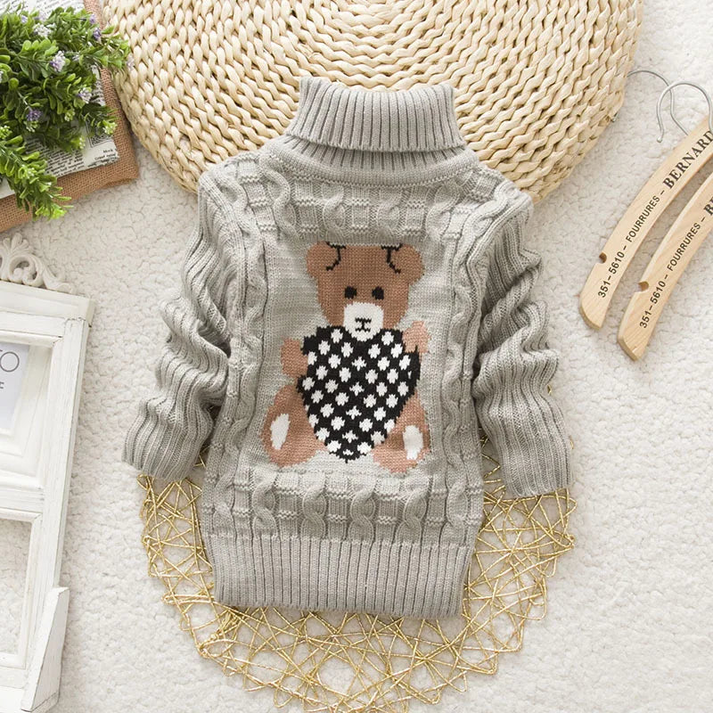 Cute baby wearing a warm teddy bear turtleneck knitwear sweater, perfect for chilly weather.