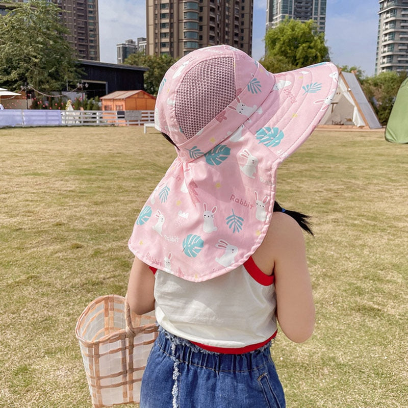 Happy child in a striped wide-brim sun hat, perfect for beach trips and ensuring UV protection all summer