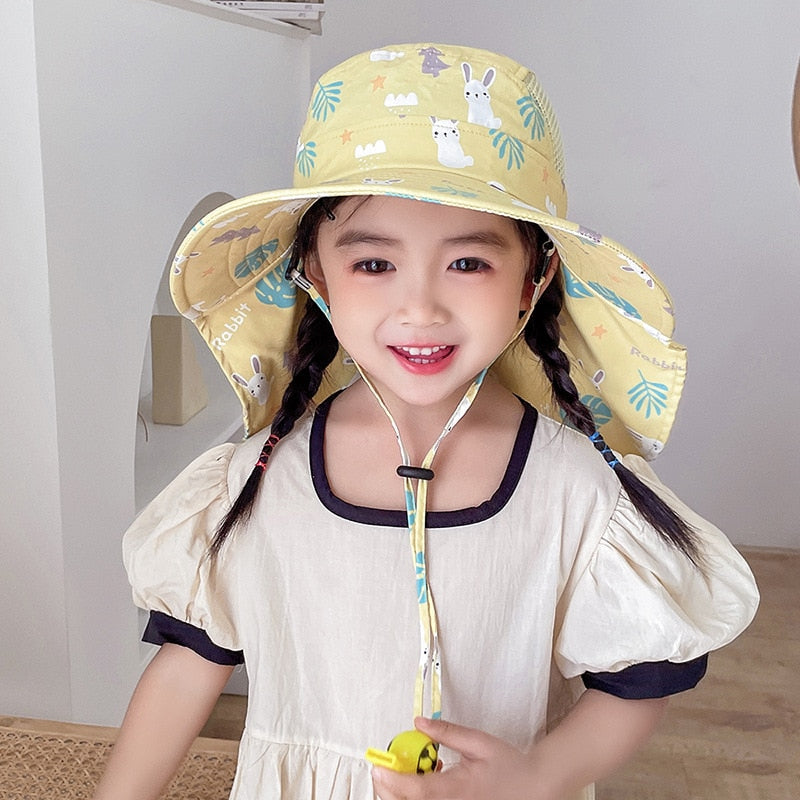 Child smiling while wearing a pink wide-brim sun hat, ideal for summer adventures and UV protection