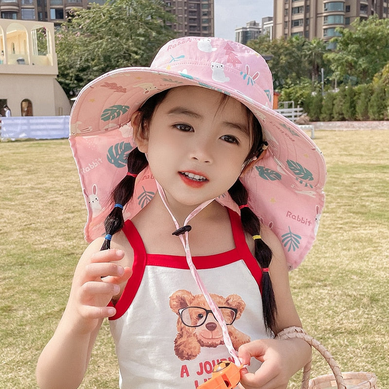 Side profile of a child wearing a green adjustable cotton sun hat, offering superior UV protection for summer