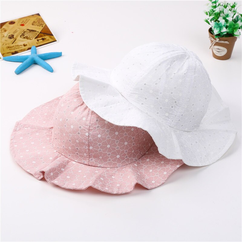 Toddler exploring outdoors wearing a light blue adjustable cotton sun hat, providing essential sun protection.