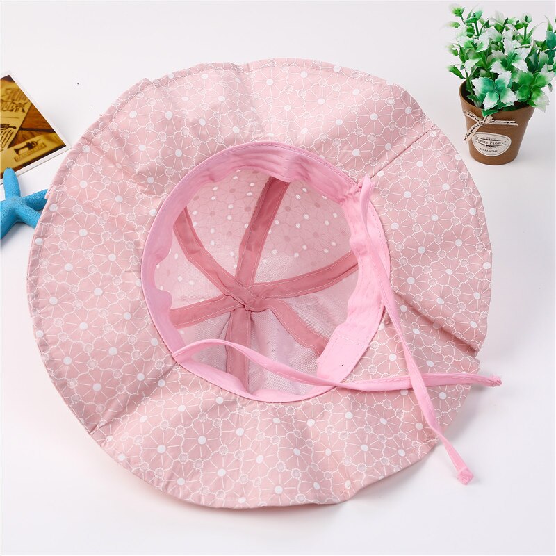 Overhead view of various kids' adjustable cotton sun hats, showcasing different colors and summer style.