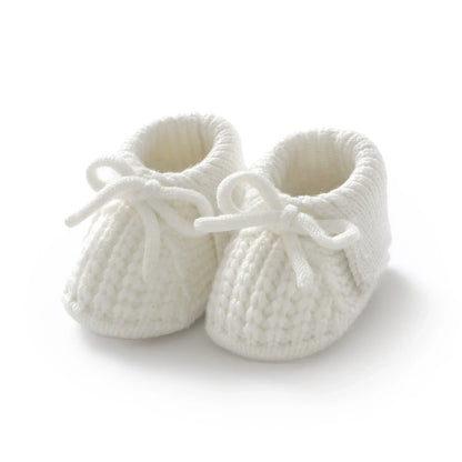 Beige knitted baby booties with a simple design, versatile unisex baby footwear, soft crib shoes
