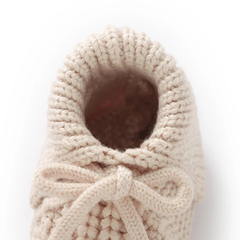Cute blue knitted baby booties, soft crib shoes with a gentle cuff, unisex baby accessory