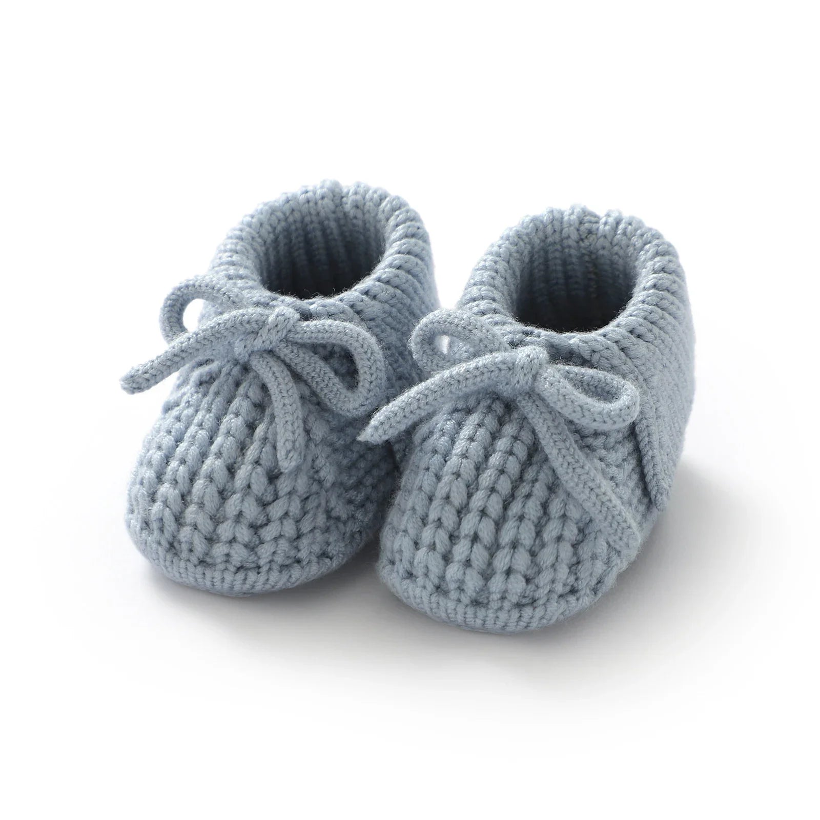 Assortment of colorful knitted baby booties, soft handmade crib shoes in various shades, baby shower gift idea