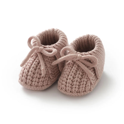 Knitted baby booties in a soft green hue, gentle infant footwear for growing babies 0-18 months