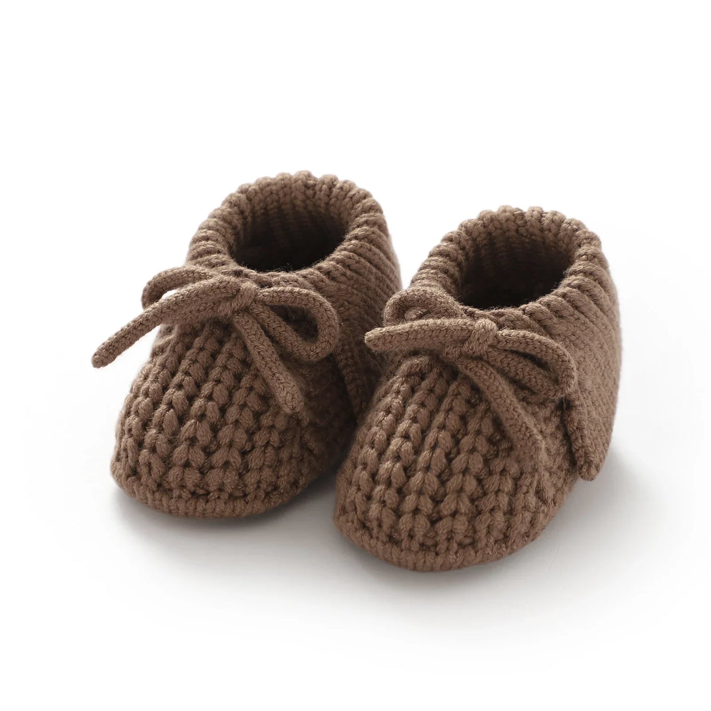 Close-up texture of knitted baby booties, plush and soft material for delicate newborn shoes