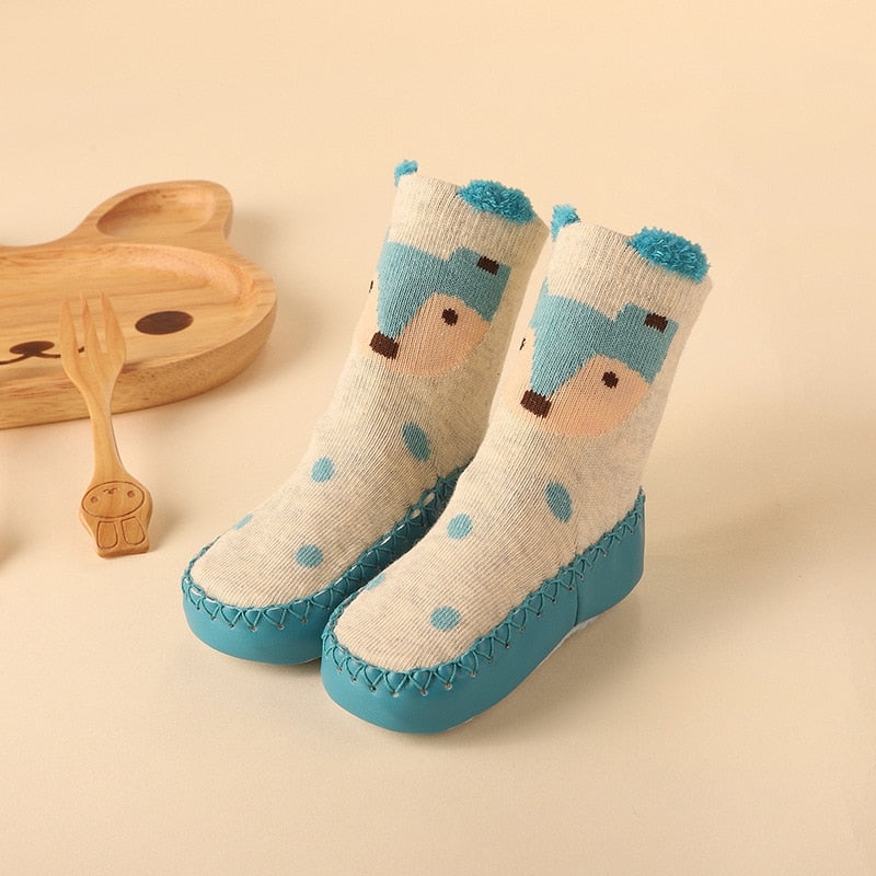 Striped baby anti-slip socks in blue and white, designed as firstwalker booties for active toddlers.