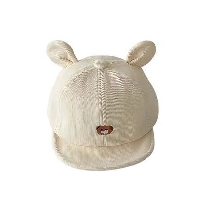 Child wearing a cute green frog character soft cotton hat, perfect for babies and toddlers.