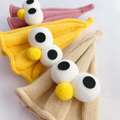 Green unisex baby hat with googly eyes, providing warmth and fun for infants.