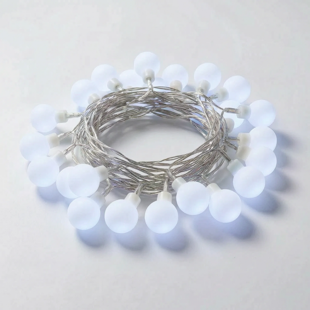 Close-up of warm white Globe LED string lights, showcasing their delicate ambient glow for any festive decor setting.