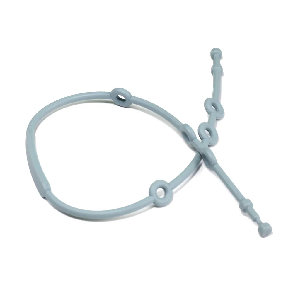 Parent attaching a baby adjustable silicone toy strap to a toy and stroller, demonstrating ease of use.