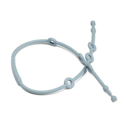 Parent attaching a baby adjustable silicone toy strap to a toy and stroller, demonstrating ease of use.