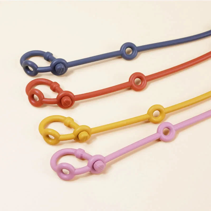 Close-up of a pink silicone toy strap with adjustable loops, perfect for baby toys and pacifiers.