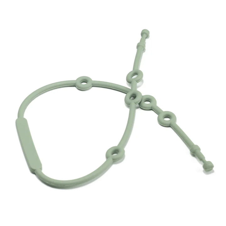 Silicone toy strap securely holding a baby's favorite plush toy, preventing it from falling on the floor.