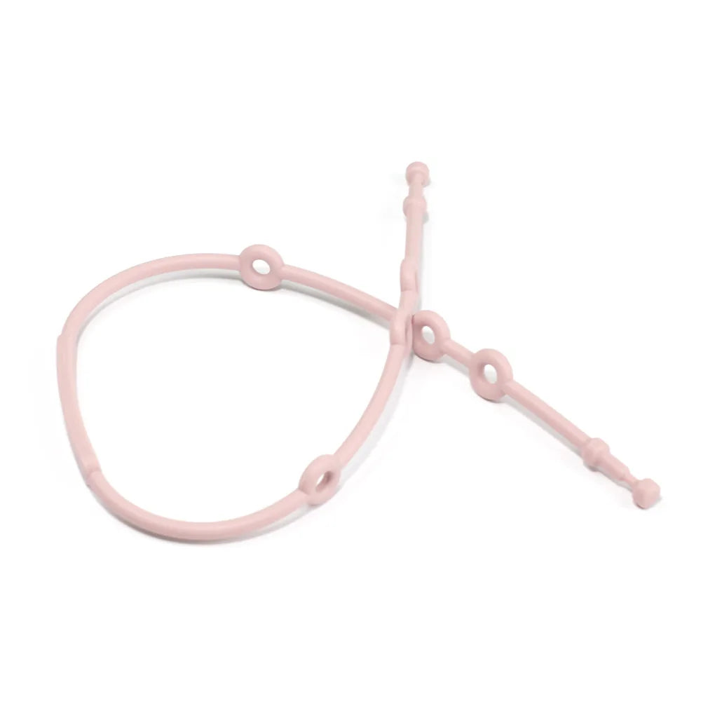 Child safety silicone strap in red, used as a pacifier holder, attached to baby's clothing.