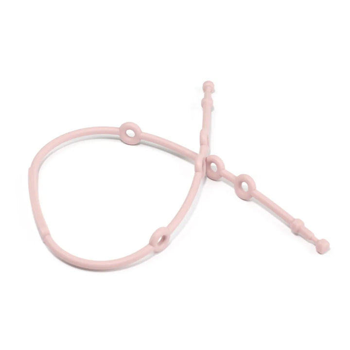 Child safety silicone strap in red, used as a pacifier holder, attached to baby's clothing.