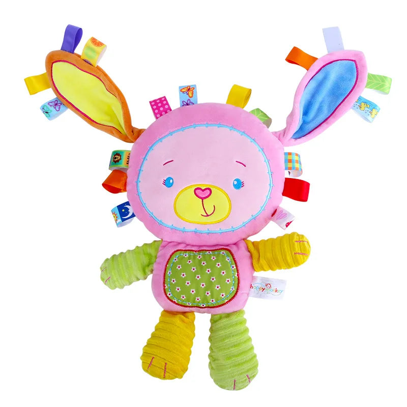 Newborn playing with a cute animal plush toy that includes rattles and bells for sound