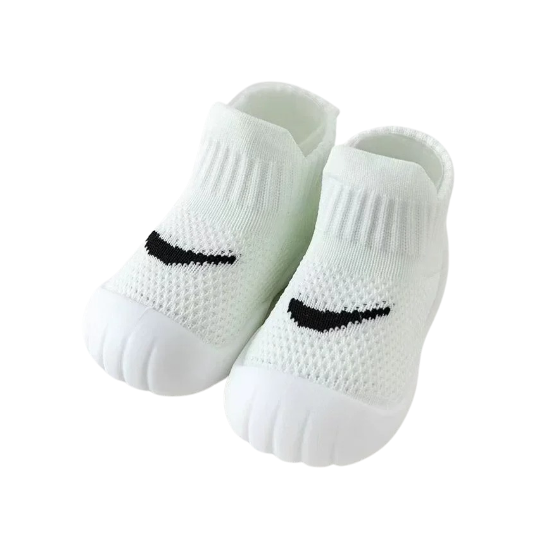 Close-up of anti-slip breathable baby first walker shoes, showing textured sole and soft fabric