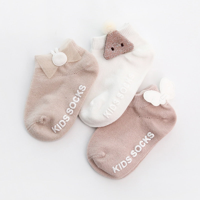 Baby wearing anti-slip cotton grip socks while crawling, providing traction for early mobility