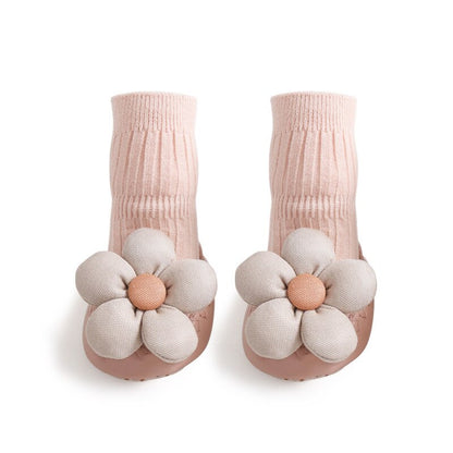 Close-up of a baby's foot in a high-neck anti-slip one-piece shoe, showing the soft cotton material.